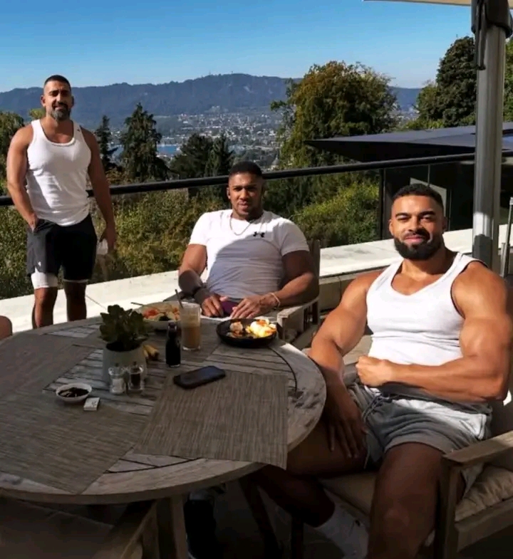 Anthony Joshua and his coach together with close friend