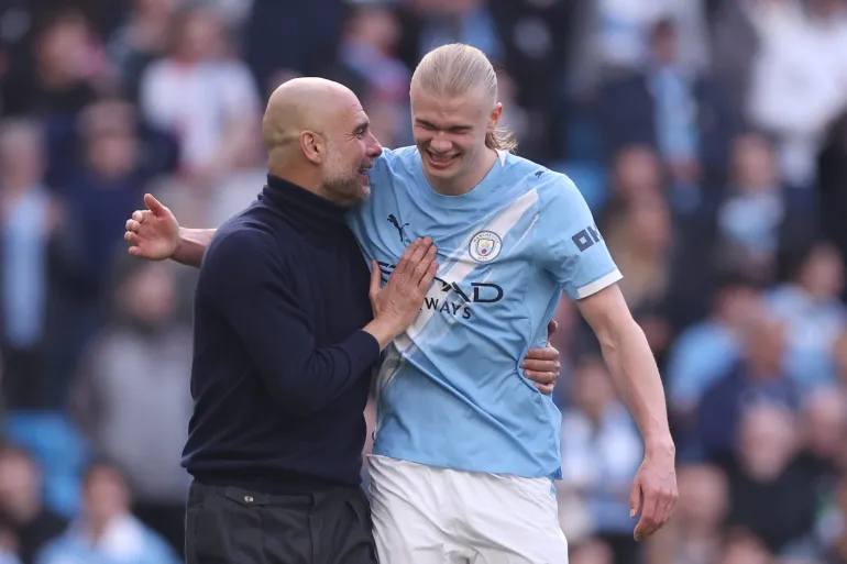 Manchester City manager Pep Guardiola and goal scorer Erling Haaland embrace after winning the match [Carl Recine/Getty Images]